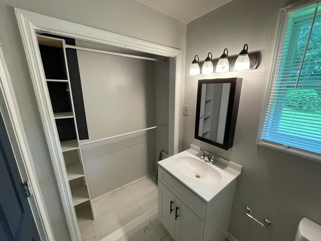 1642 Mary George Avenue Northwest Atlanta, GA 30318 - Photo 20 of 33 a bathroom with a sink and mirror with toilet