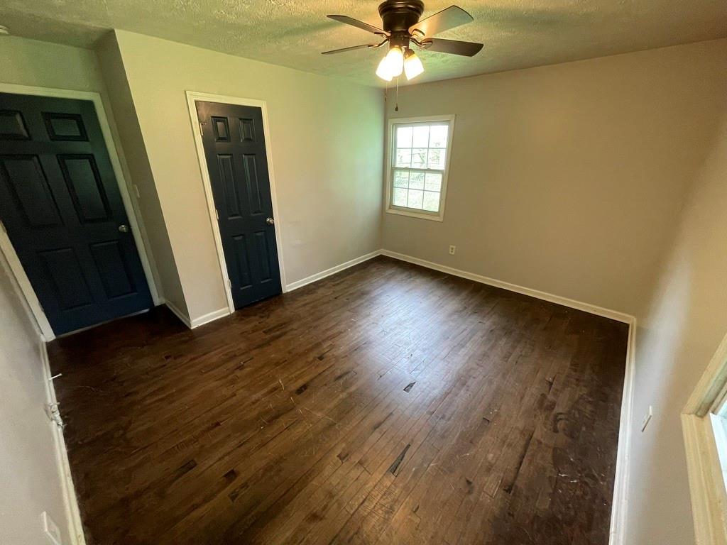 1642 Mary George Avenue Northwest Atlanta, GA 30318 - Photo 21 of 33 a view of an empty room with wooden floor and a window