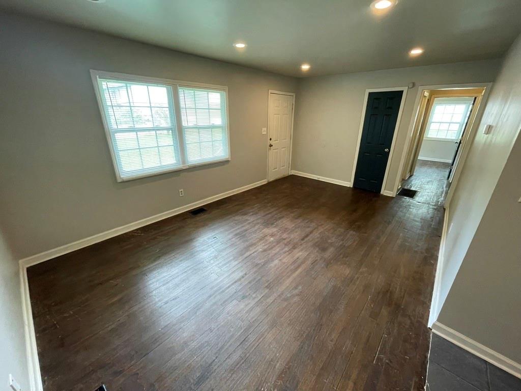 1642 Mary George Avenue Northwest Atlanta, GA 30318 - Photo 6 of 33 an empty room with wooden floor and windows