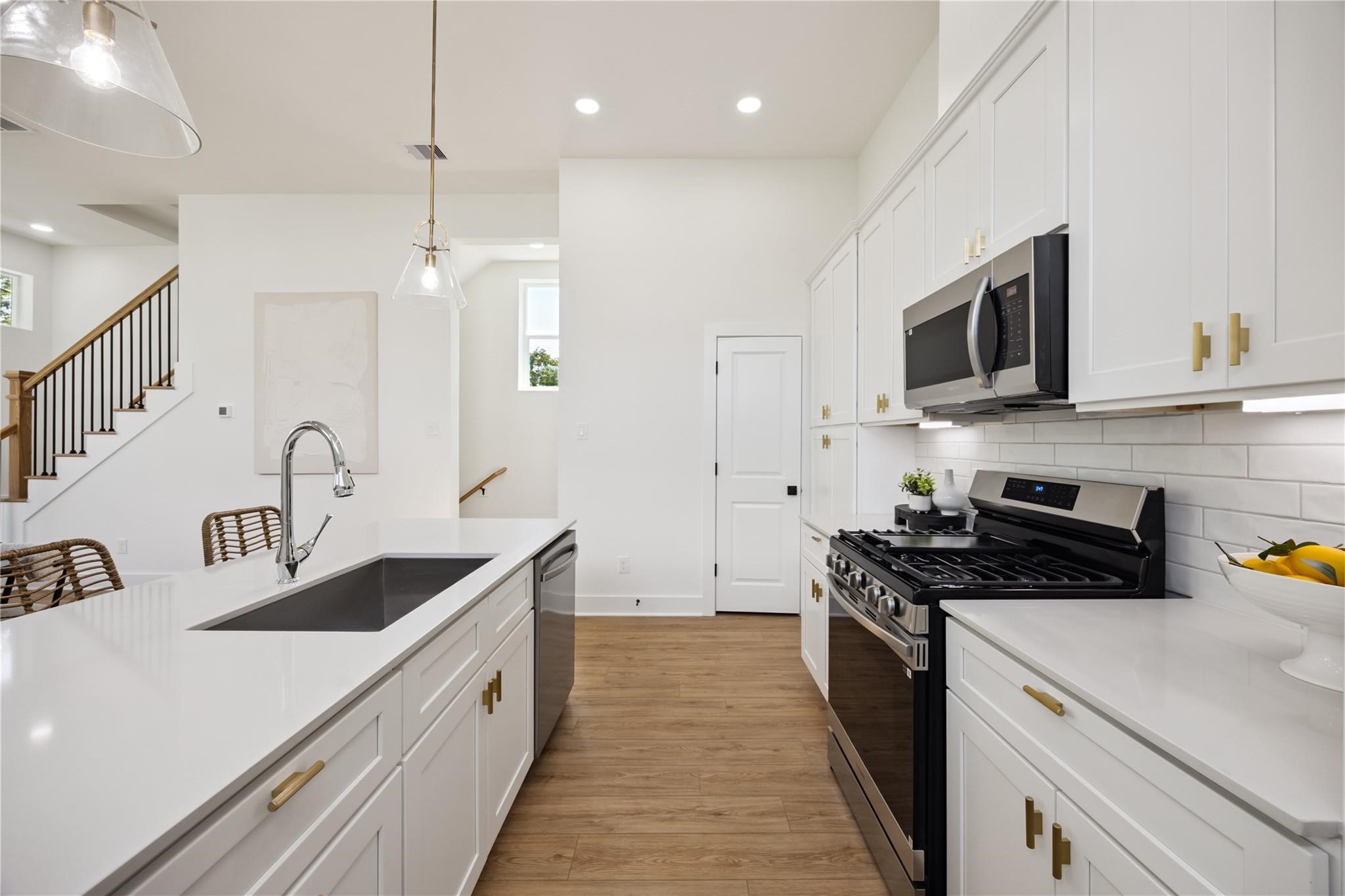 835 Rachel Street, Unit D Houston, TX 77091 - Photo 6 of 22 a kitchen with stainless steel appliances granite countertop a sink stove and refrigerator