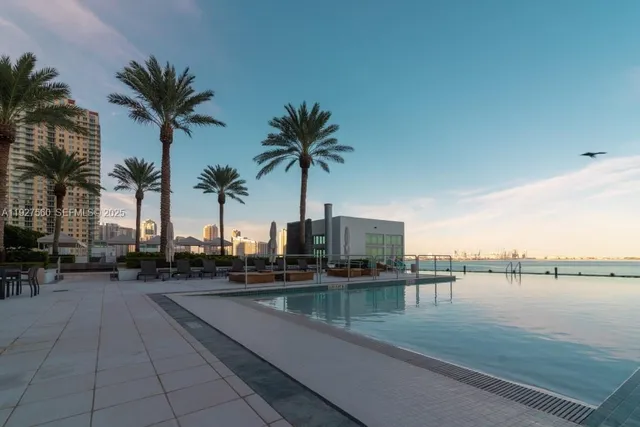 a view of swimming pool with table and chairs