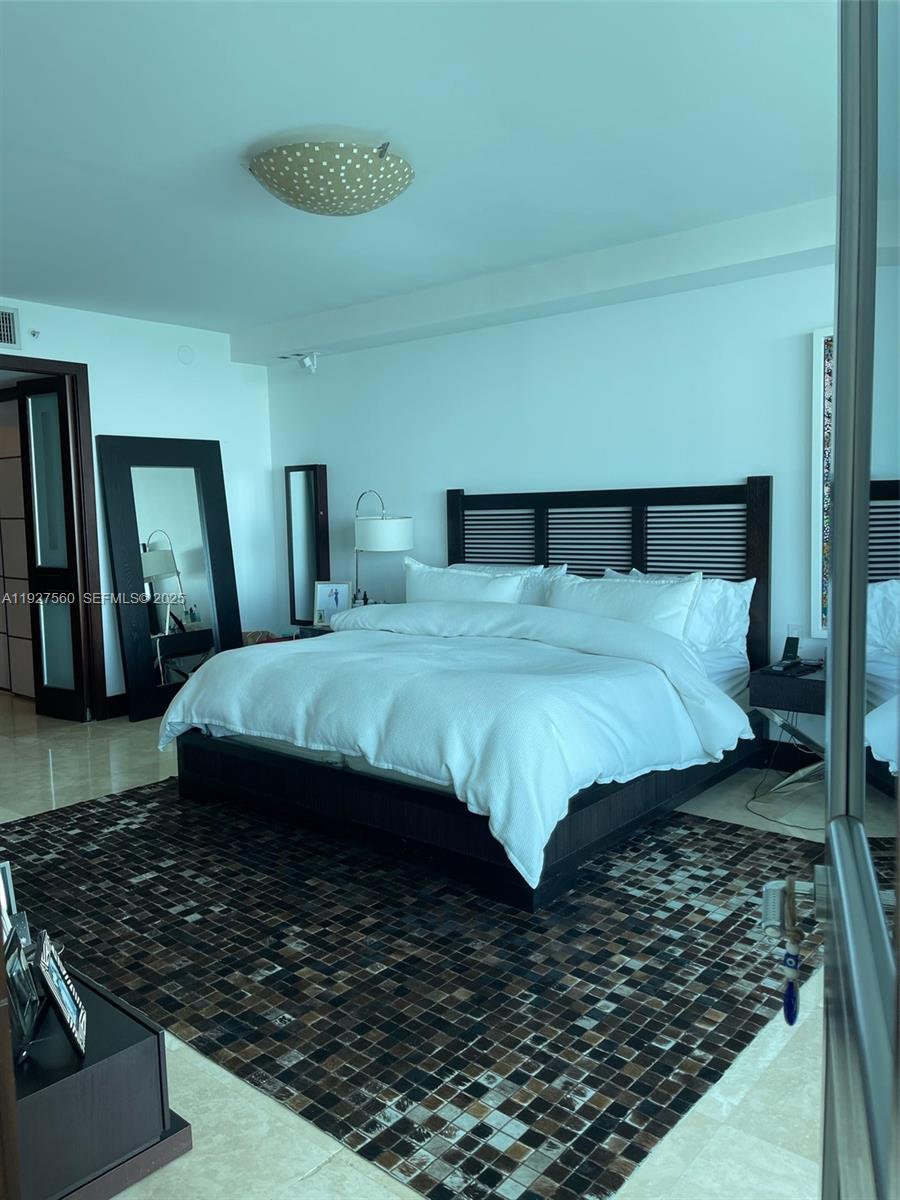 1331 Brickell Bay Drive, Unit 3607 Miami, FL 33131 - Photo 11 of 35 a bedroom with a bed and a walk in closet