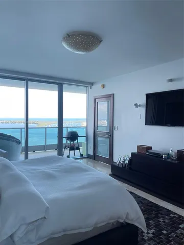 a swimming pool with a large window and couch