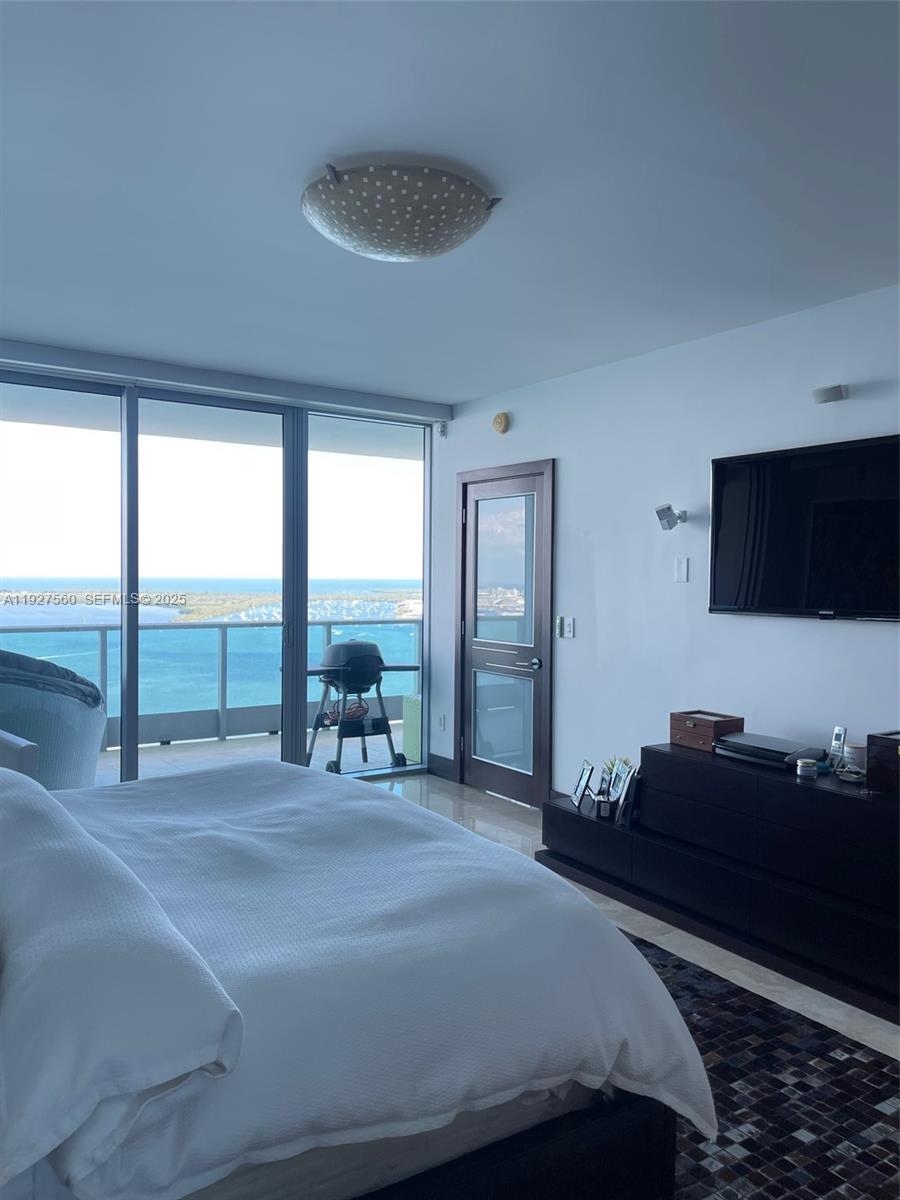 1331 Brickell Bay Drive, Unit 3607 Miami, FL 33131 - Photo 12 of 35 a bedroom with a bed and large windows