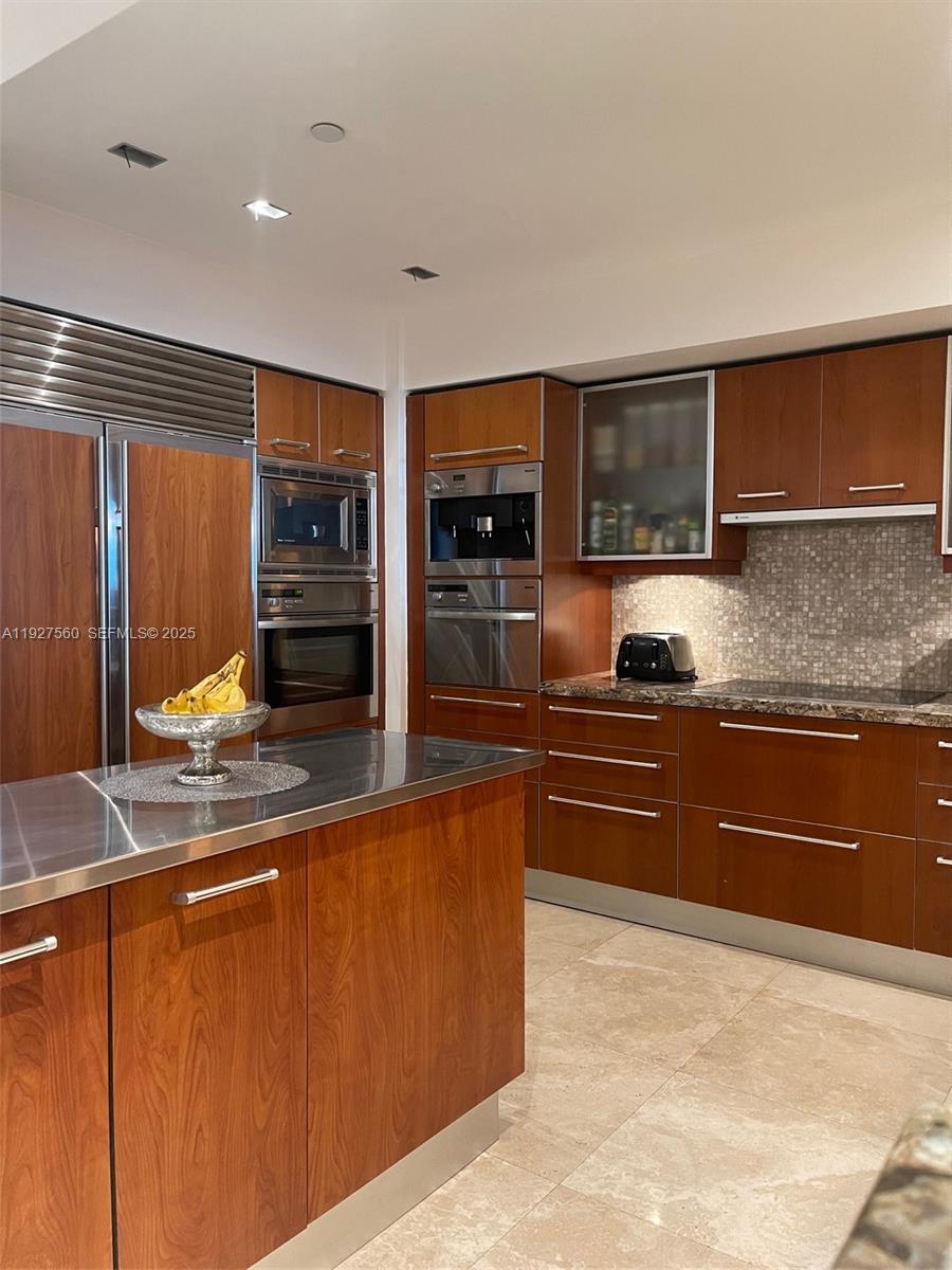 1331 Brickell Bay Drive, Unit 3607 Miami, FL 33131 - Photo 16 of 35 a kitchen with stainless steel appliances granite countertop a refrigerator and a stove top oven