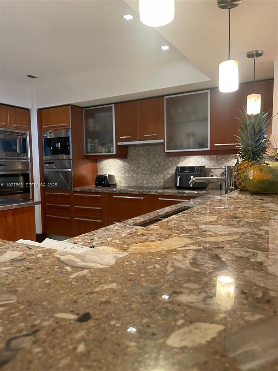 1331 Brickell Bay Drive, Unit 3607 Miami, FL 33131 - Photo 20 of 35 a view of a kitchen with kitchen island a sink stainless steel appliances and cabinets