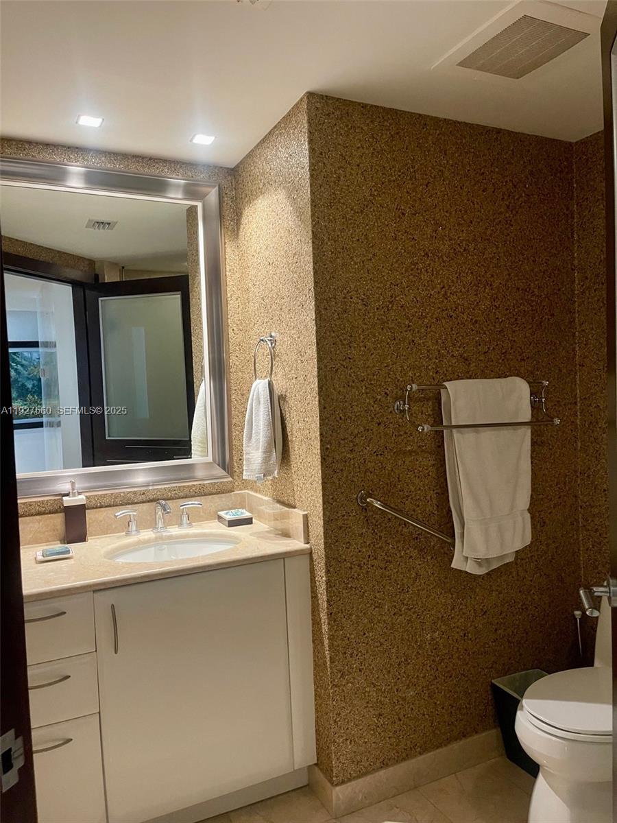 1331 Brickell Bay Drive, Unit 3607 Miami, FL 33131 - Photo 30 of 35 a bathroom with a sink a toilet and mirror