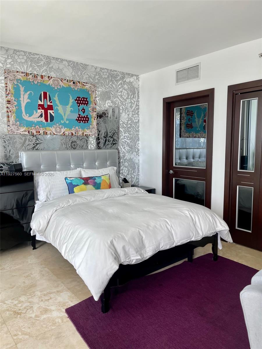 1331 Brickell Bay Drive, Unit 3607 Miami, FL 33131 - Photo 34 of 35 a bedroom with a bed and dresser