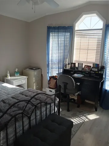 a bed room with furniture and two beds