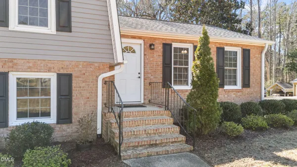 a front view of a house with a garden