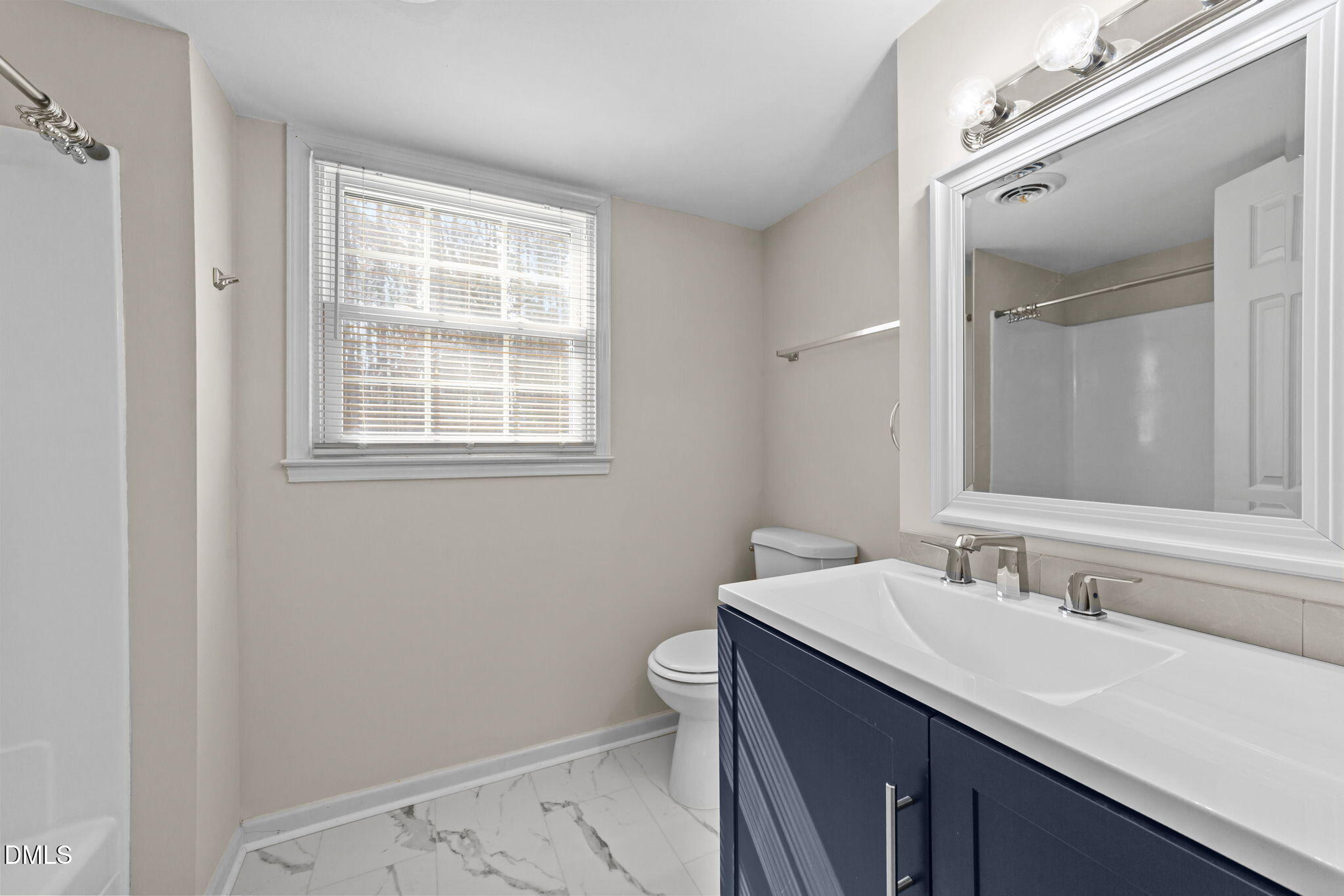 205 November Street Garner, NC 27529 - Photo 14 of 26 a bathroom with a sink a toilet and a mirror