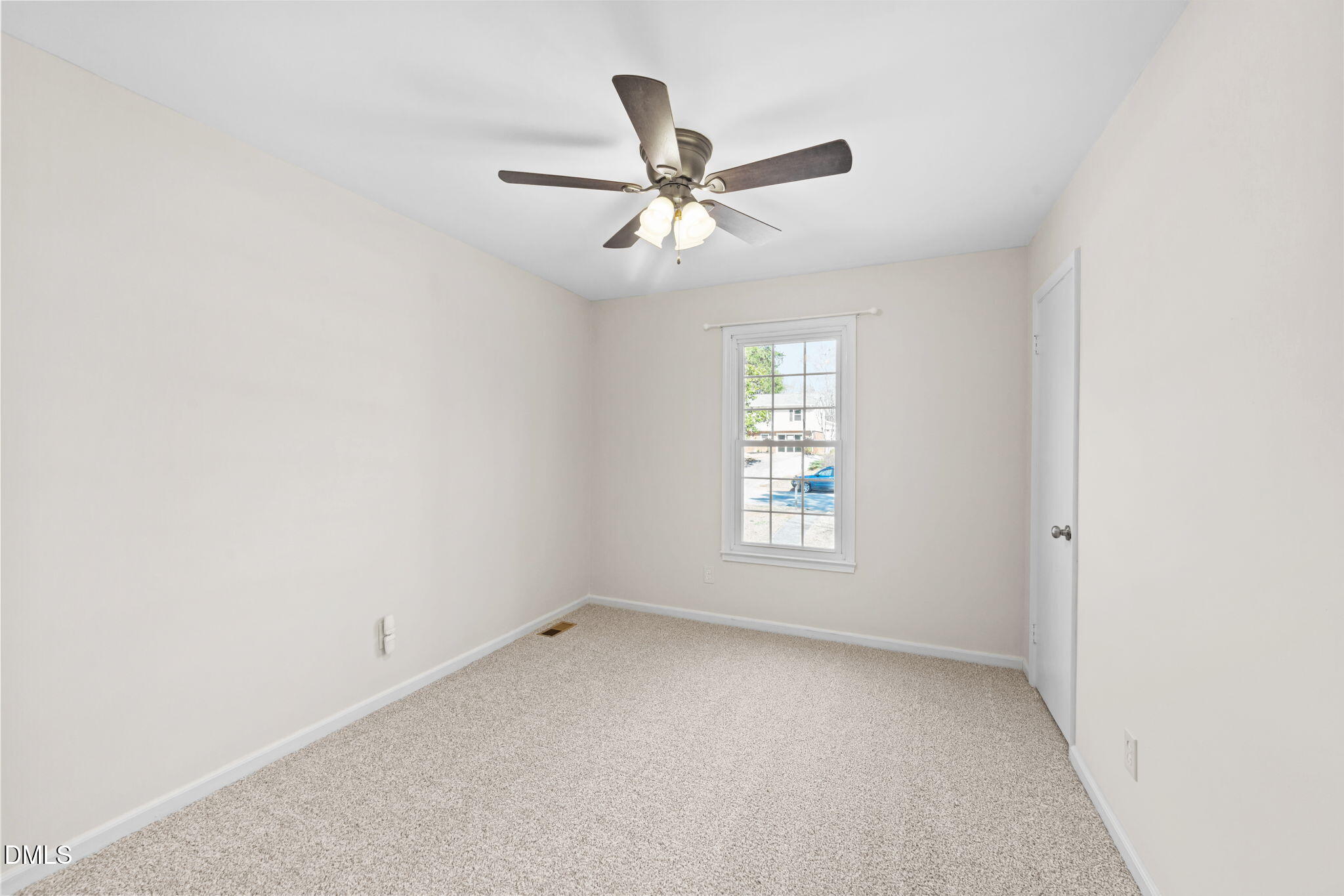 205 November Street Garner, NC 27529 - Photo 17 of 26 an empty room with a window and a fan