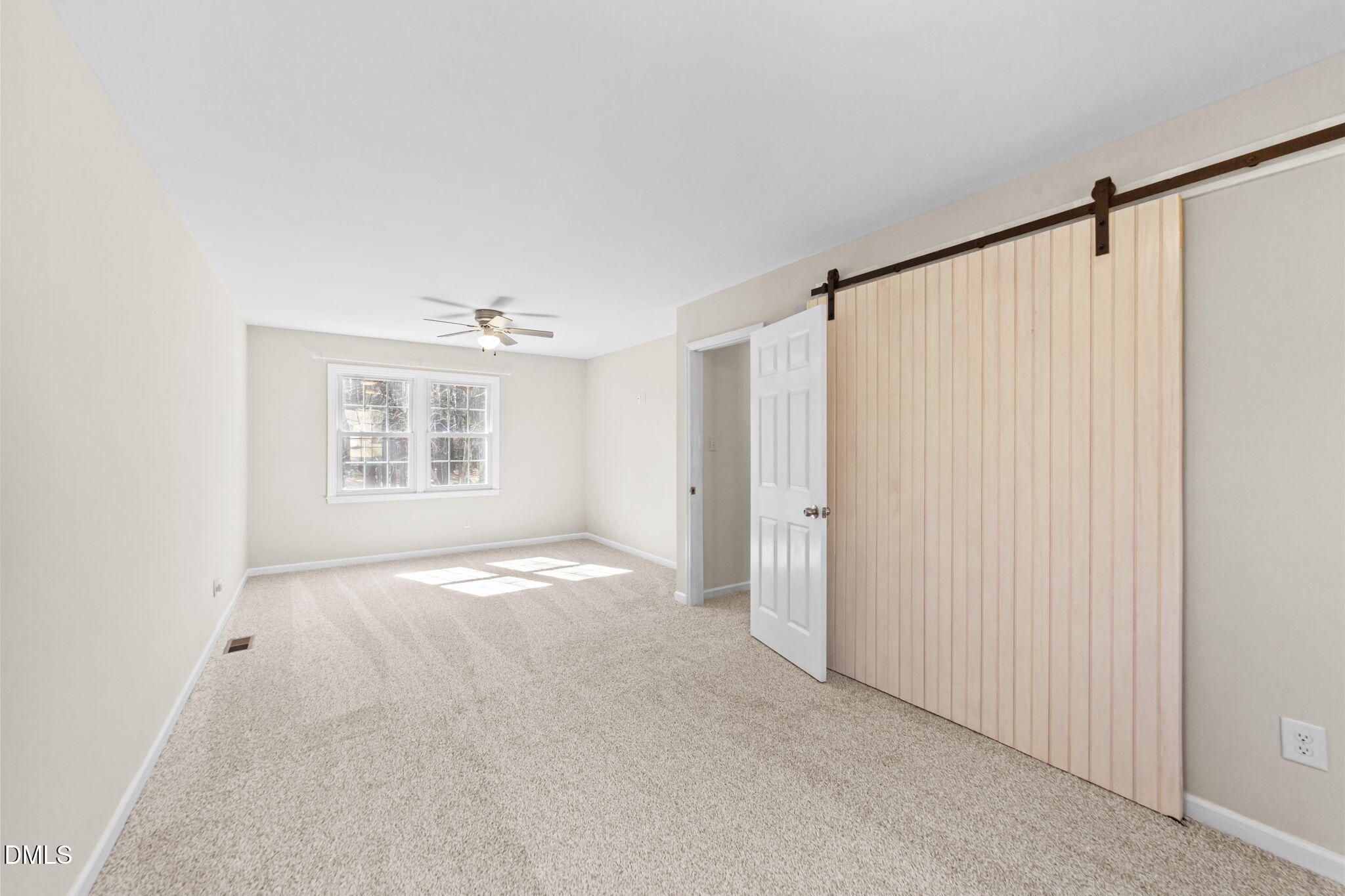 205 November Street Garner, NC 27529 - Photo 19 of 26 an empty room with windows and closet