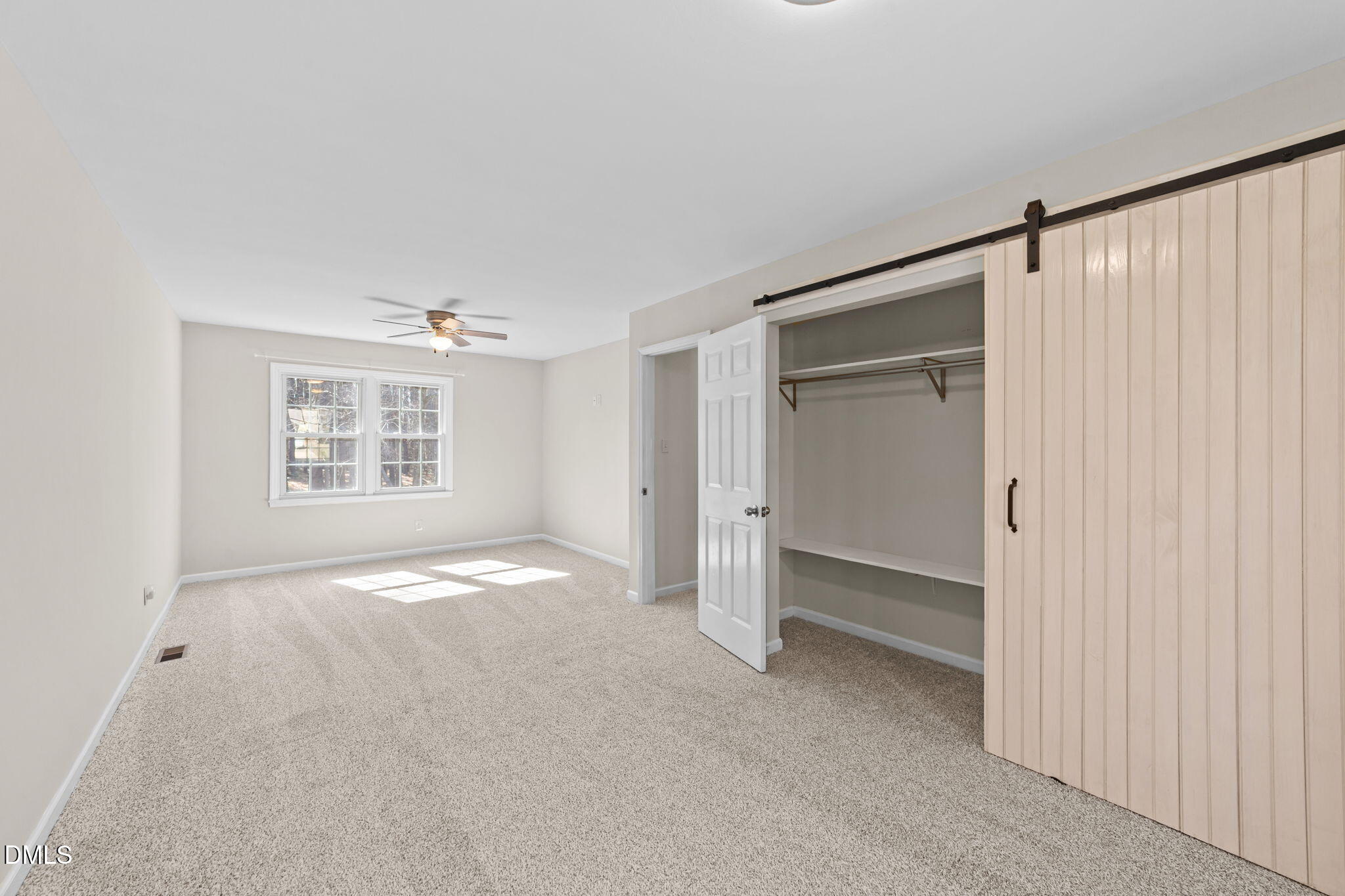 205 November Street Garner, NC 27529 - Photo 21 of 26 a view of an empty room with a window and a kitchen