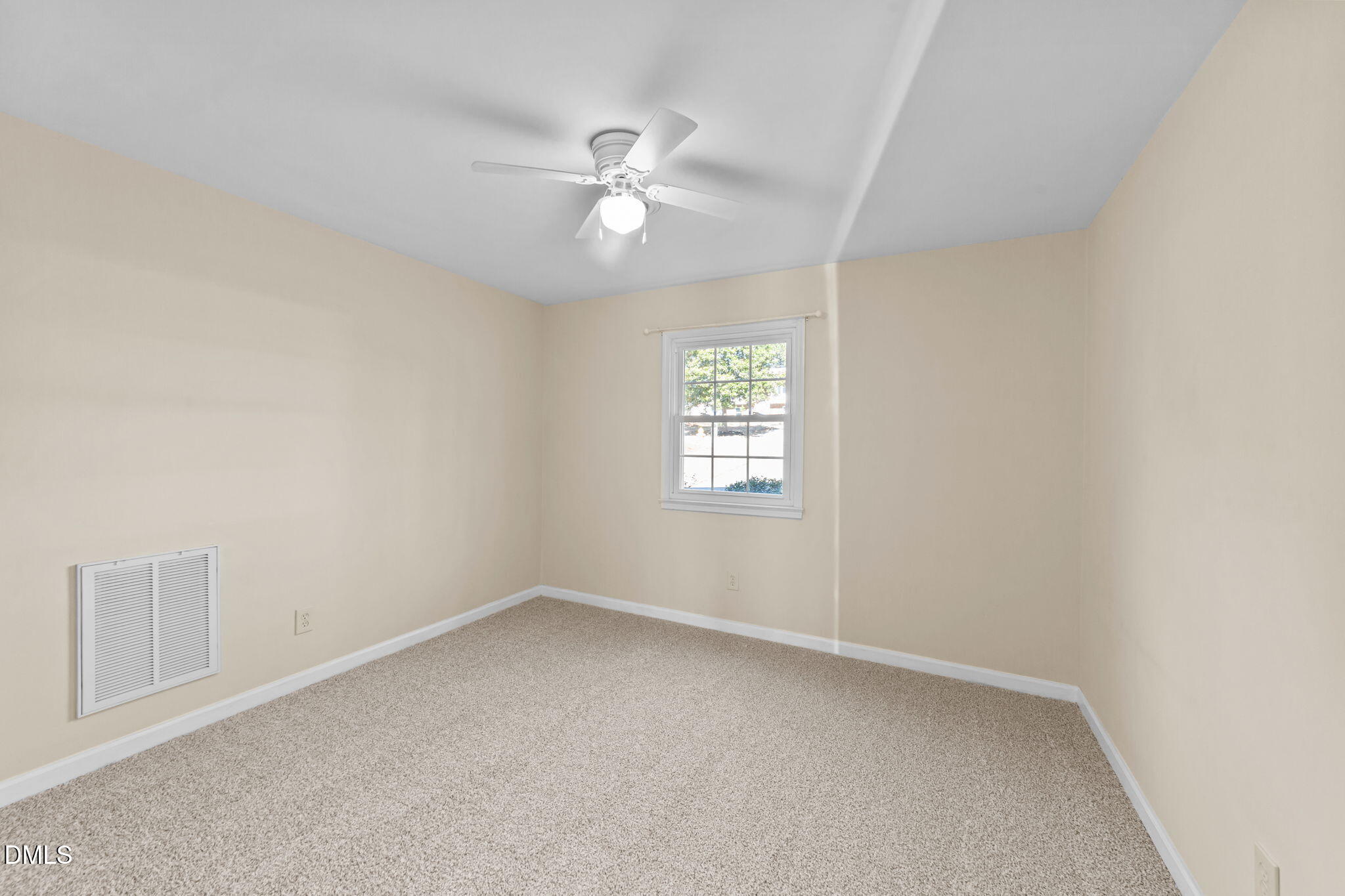 205 November Street Garner, NC 27529 - Photo 23 of 26 an empty room with windows and fan