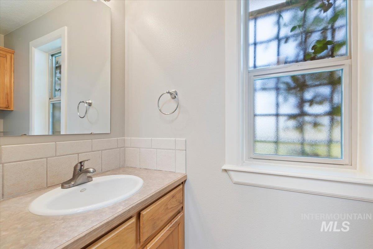 24240 Tiger Lane Caldwell, ID 83607 - Photo 18 of 50 Bathroom off garage entrance to house through utility. Window with privacy glass