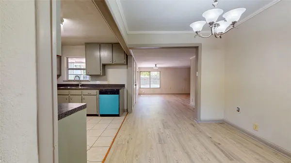 a view of kitchen with sink and refrigerator