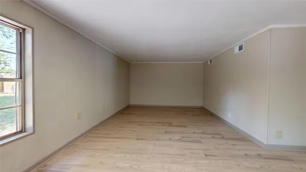 an empty room with a empty space and window