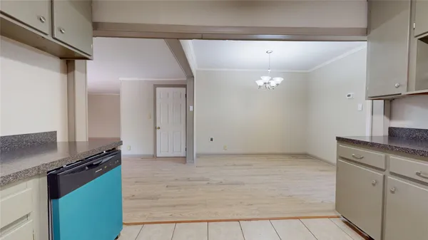 a kitchen with a refrigerator and a stove top oven