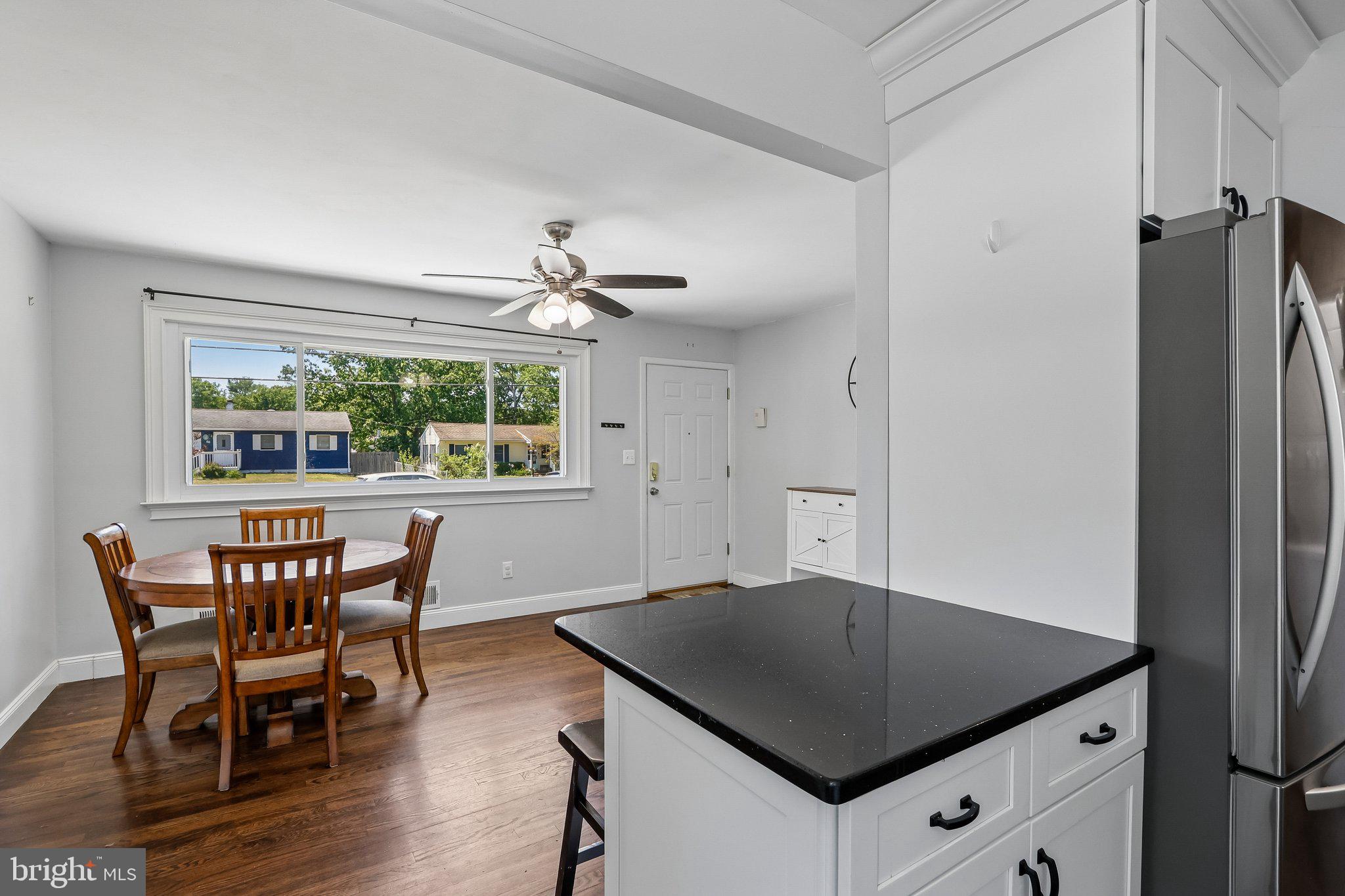 73 Burnt Tavern Road Brick, NJ 08724 - Photo 8 of 31 a kitchen with stainless steel appliances granite countertop a table chairs and a refrigerator