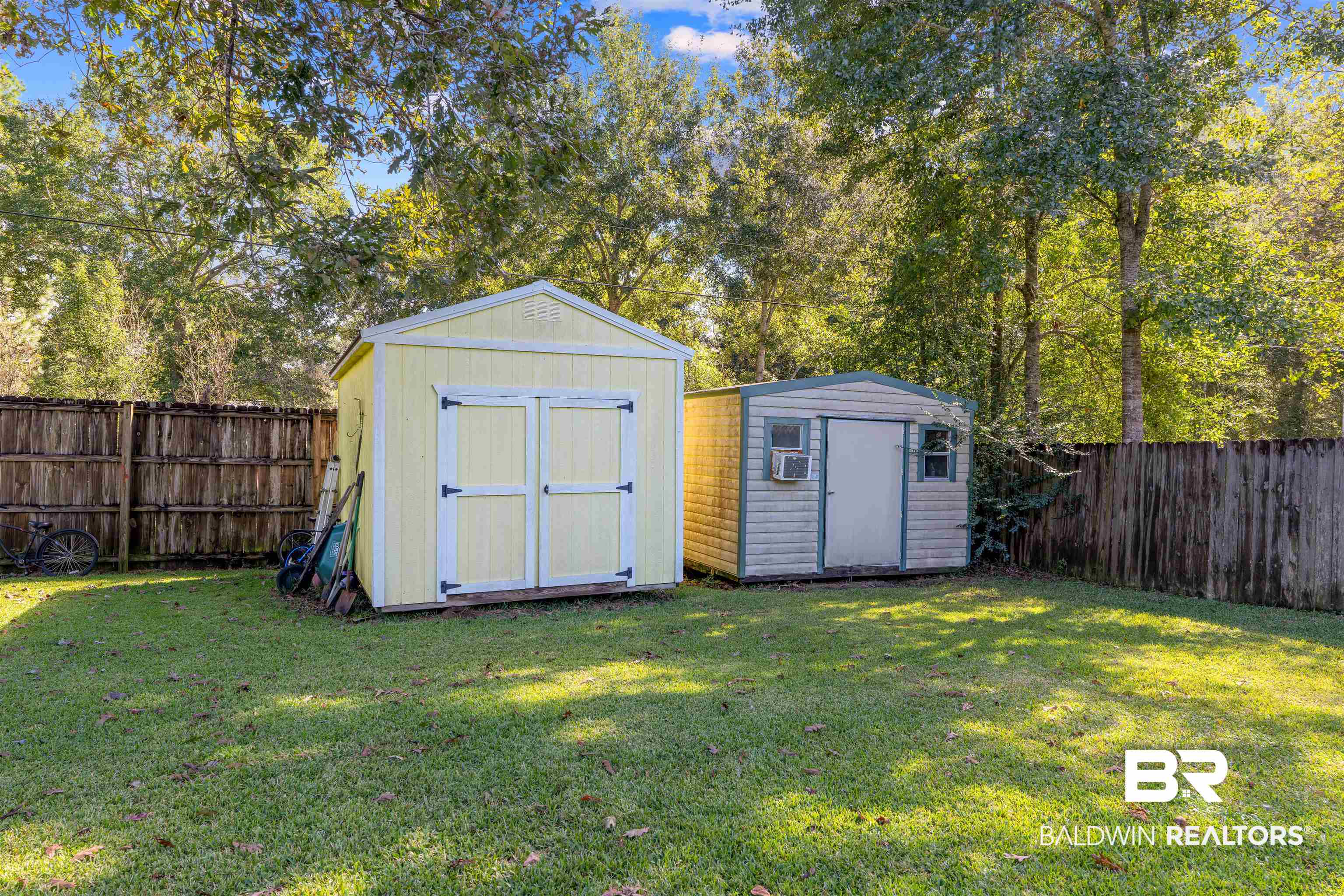 23186 Pecan Street Robertsdale, AL 36567 - Photo 26 of 36 View of shed with a fenced backyard and view of scattered trees