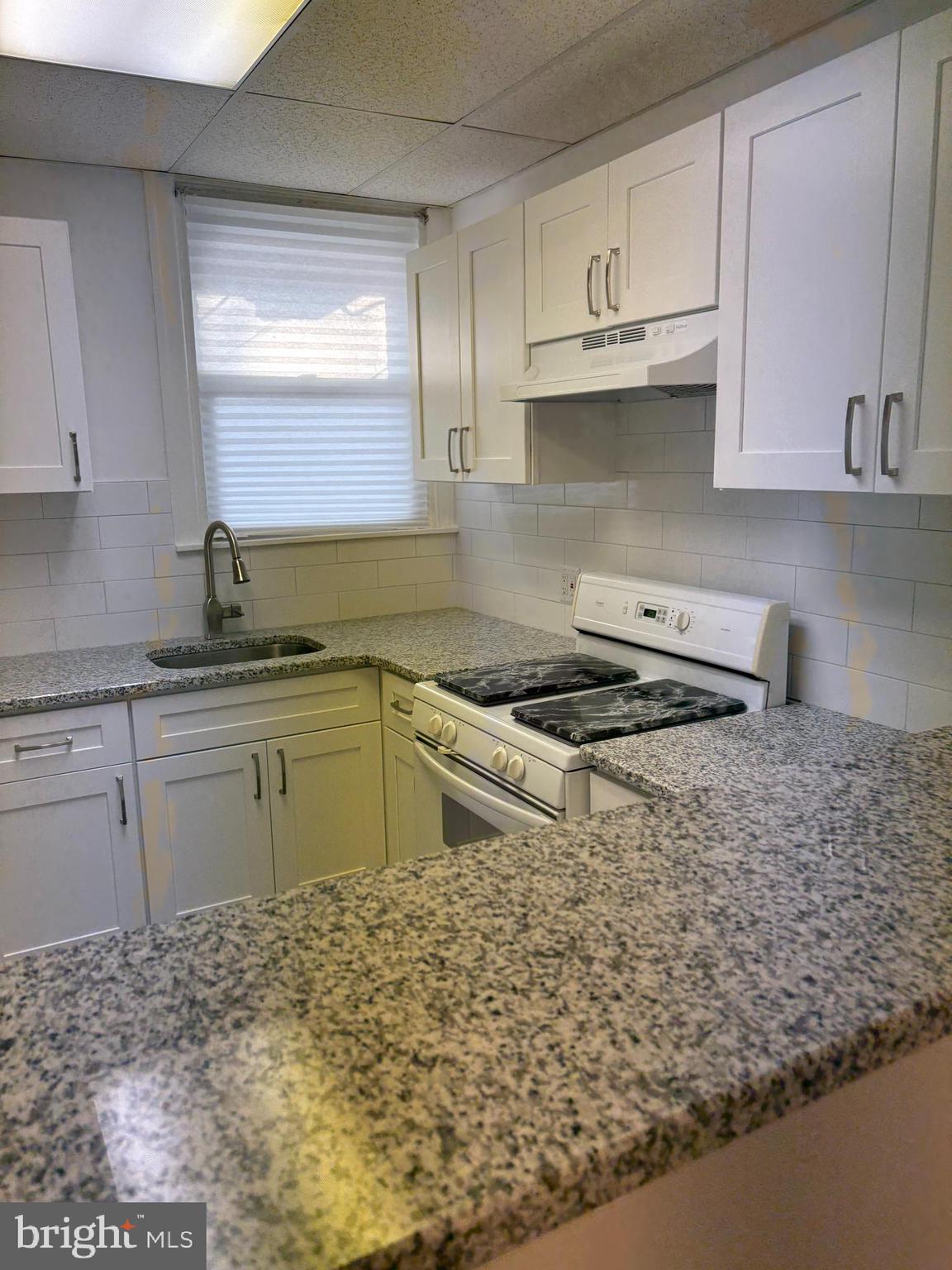 1934 73rd Avenue Philadelphia, PA 19138 - Photo 14 of 48 a kitchen with granite countertop a sink and cabinets