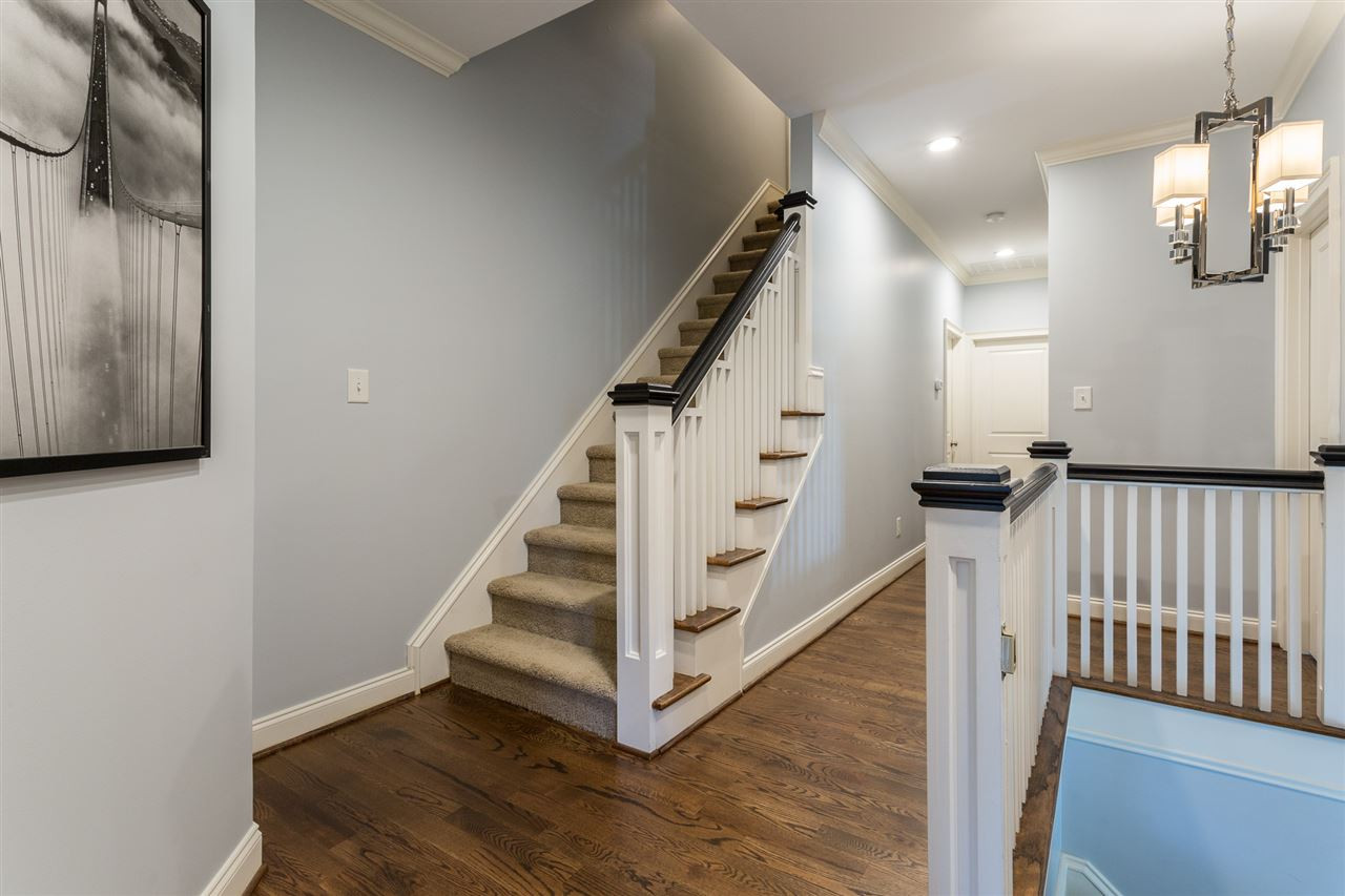1716 Stannard Trail Raleigh, NC 27612 - Photo 13 of 30 The second floor landing and hallway features beautiful hardwoods floors and custom wood spindles on both staircases. A large double-door linen closet is located at one end of the hallway. 2nd Floor Landing and Staircase to 3rd Floor