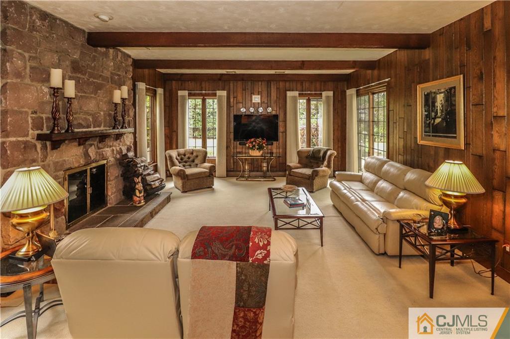 2 Lynn Way Colonia, NJ 07067 - Photo 22 of 50 a living room with furniture and a fireplace