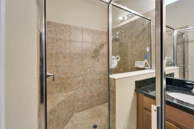 a bathroom with a shower and a sink