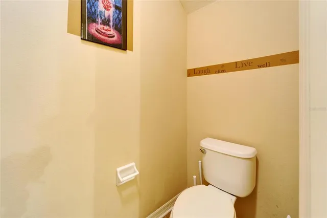 a white toilet sitting next to a shower curtain