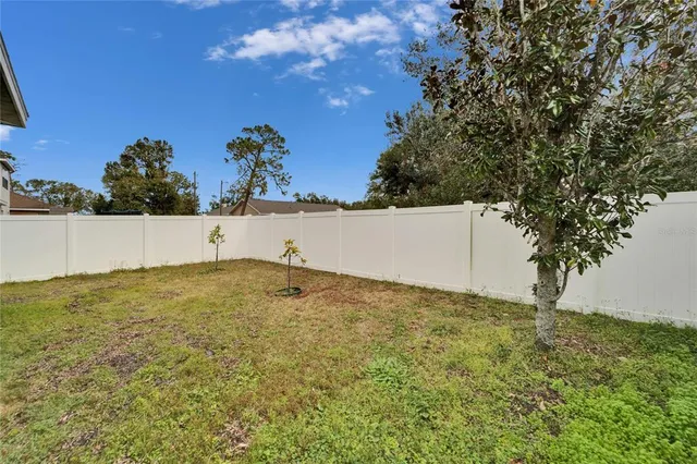 a front view of a house with garden and parking