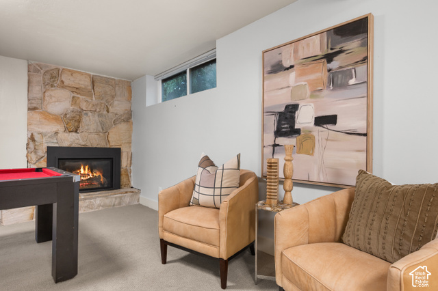 8678 Mount Majestic Road Sandy, UT 84093 - Photo 24 of 37 Stone-clad fireplace with a raised hearth, broad-frame window, and neutral wall paint