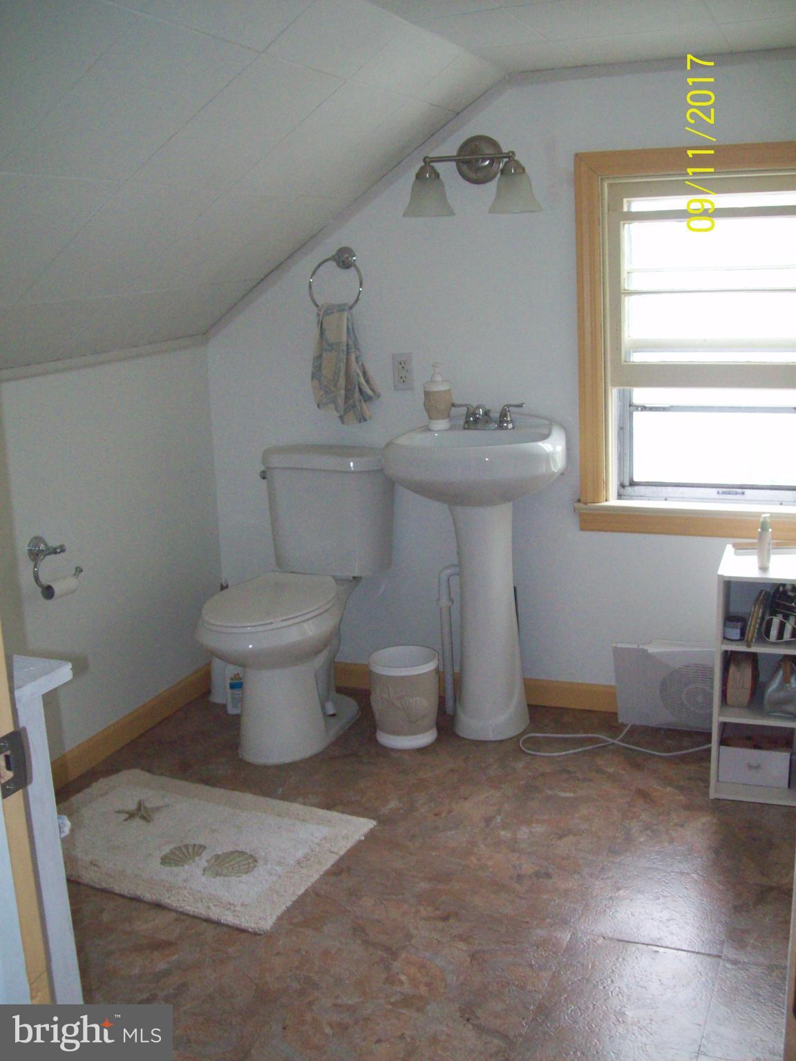 12411 Big Spring Road Clear Spring, MD 21722 - Photo 15 of 17 a bathroom with a sink toilet and a window