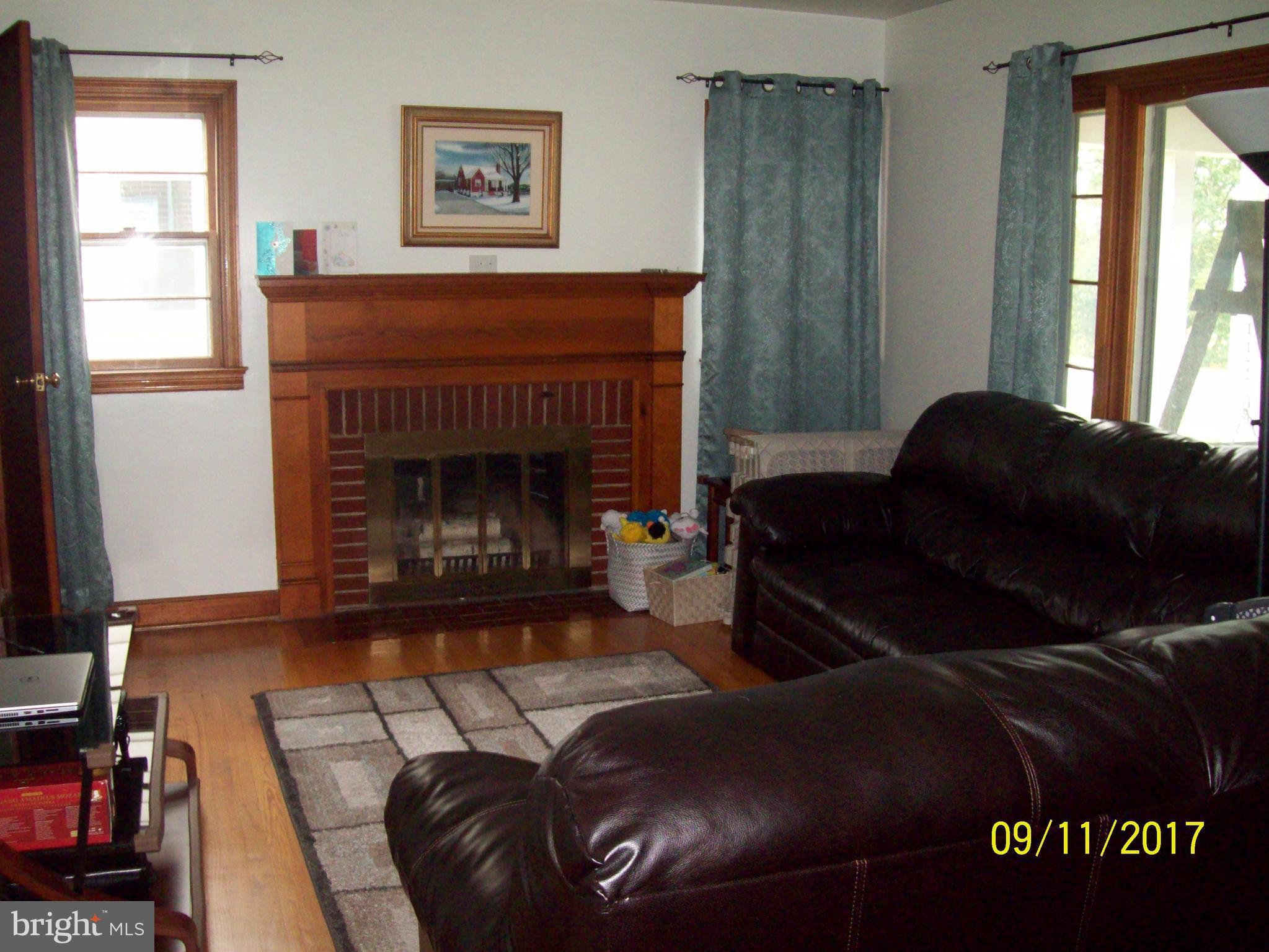 12411 Big Spring Road Clear Spring, MD 21722 - Photo 3 of 17 a living room with furniture and a fireplace