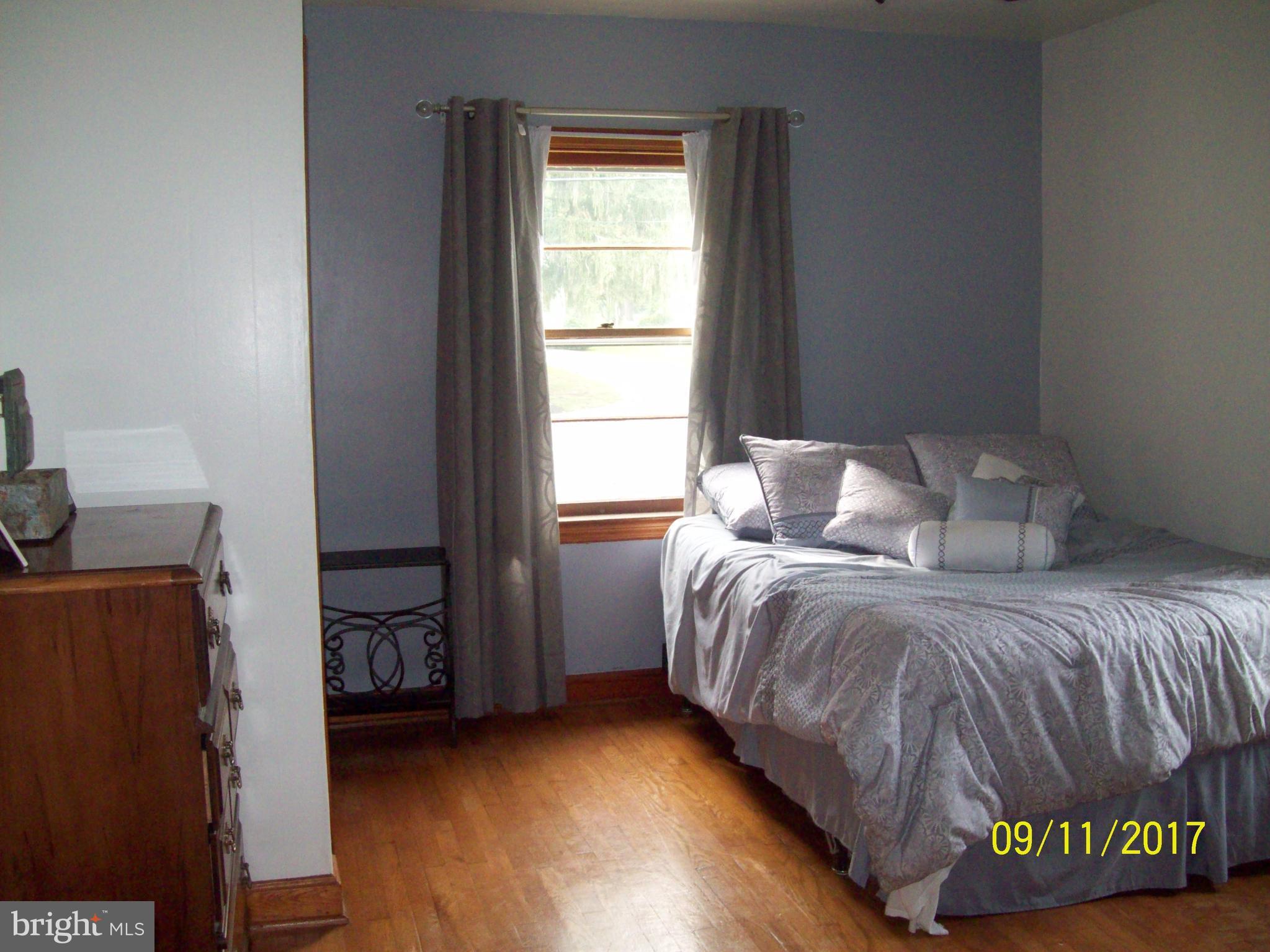 12411 Big Spring Road Clear Spring, MD 21722 - Photo 4 of 17 a bedroom with a bed and window