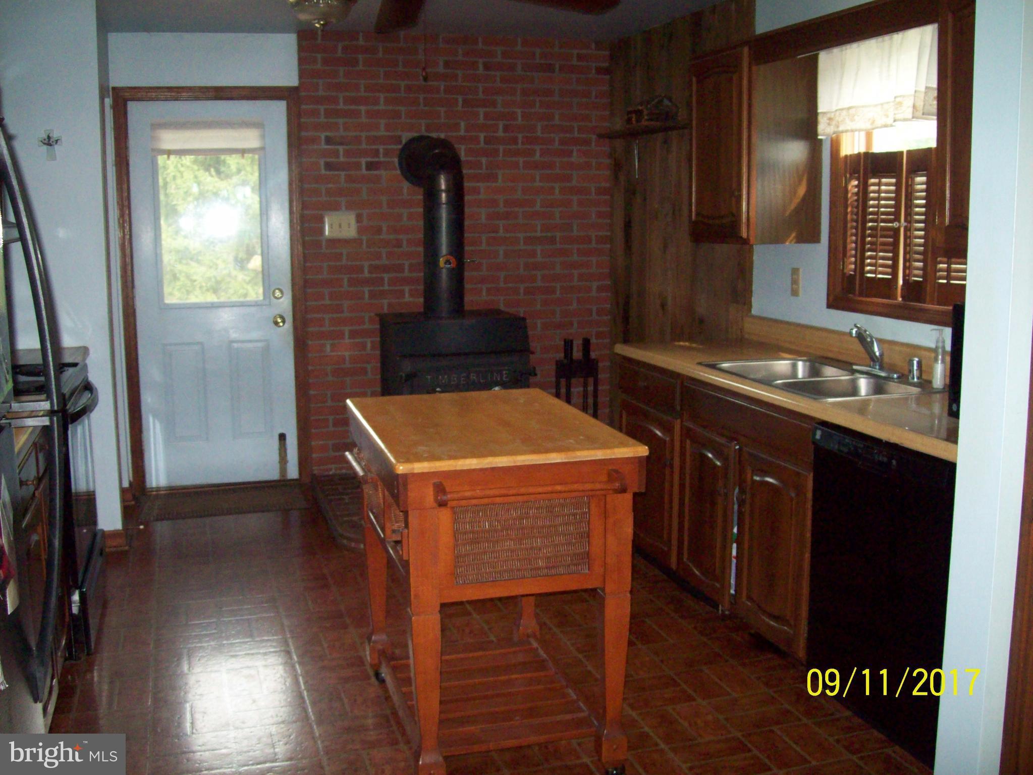 12411 Big Spring Road Clear Spring, MD 21722 - Photo 10 of 17 a kitchen that has a sink a stove and a refrigerator