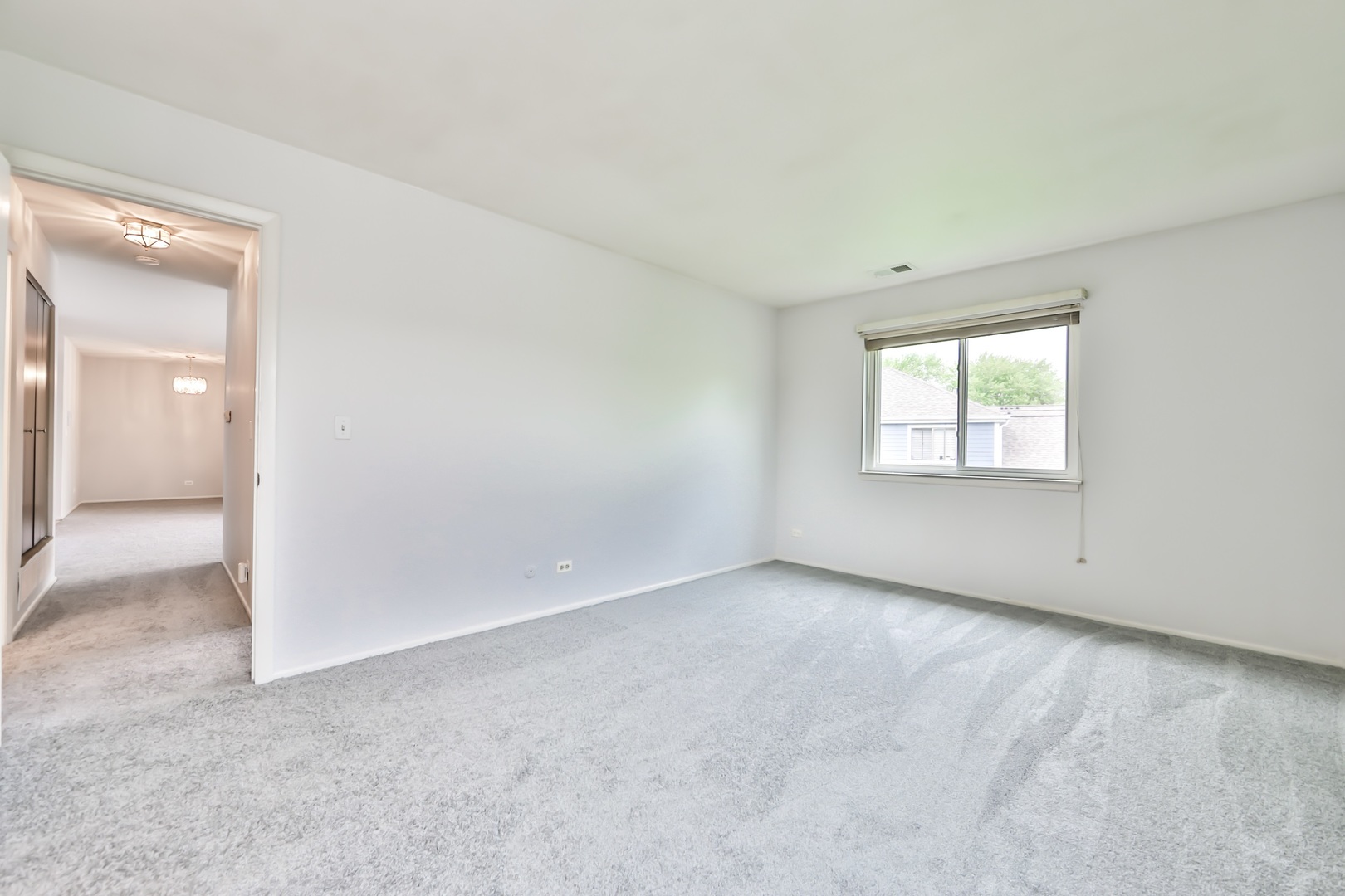 1502 7 Pines Road, Unit D2 Schaumburg, IL 60193 - Photo 12 of 34 an empty room with windows and closet