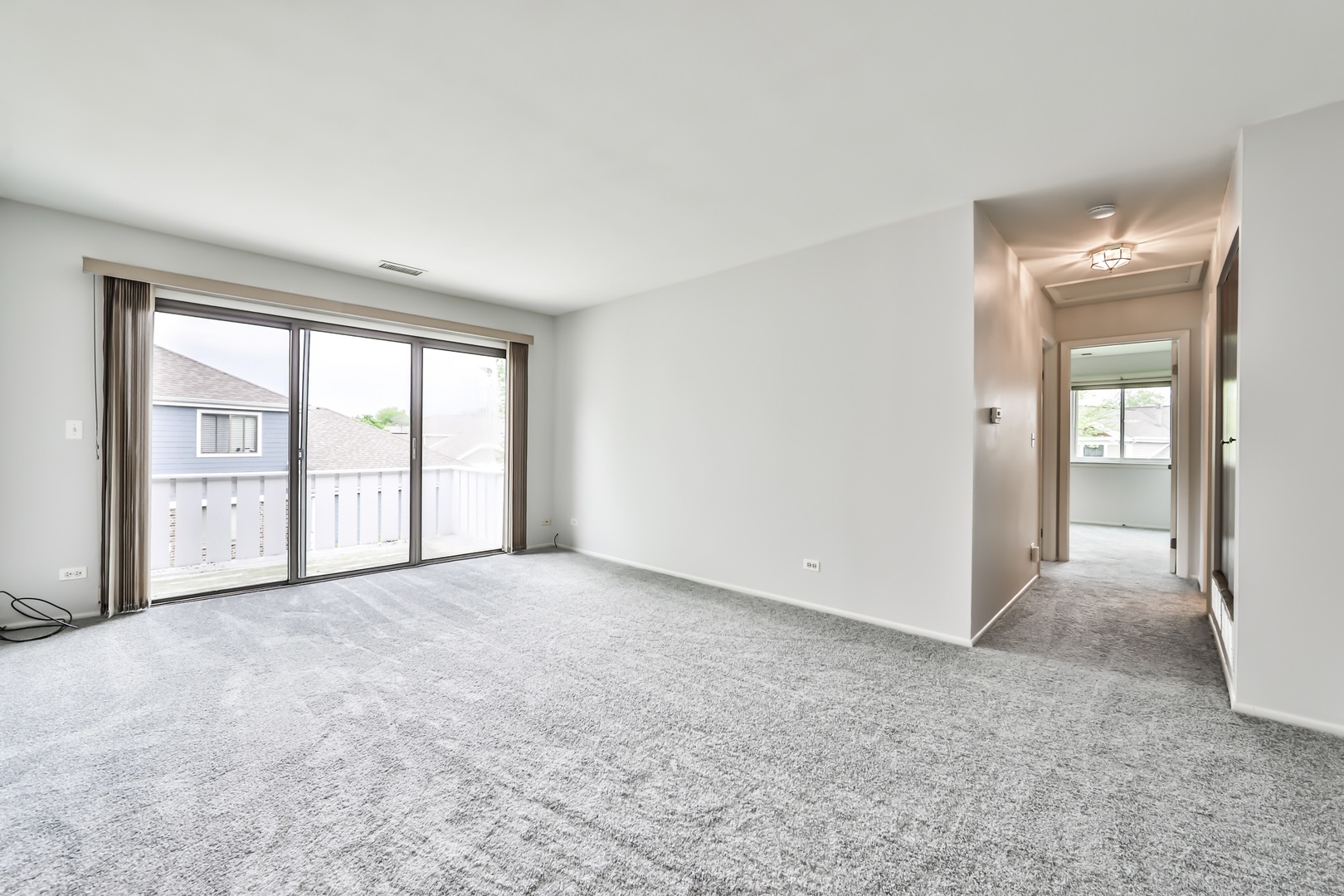 1502 7 Pines Road, Unit D2 Schaumburg, IL 60193 - Photo 3 of 34 a view of an empty room with glass door