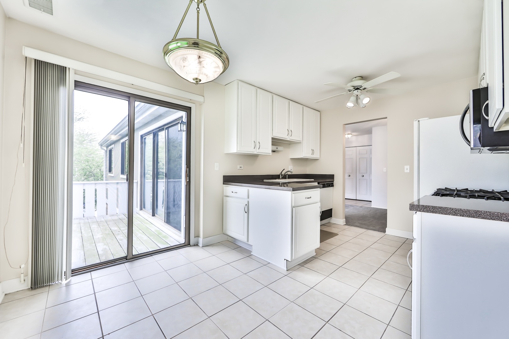 1502 7 Pines Road, Unit D2 Schaumburg, IL 60193 - Photo 28 of 34 a kitchen with white cabinets and white appliances