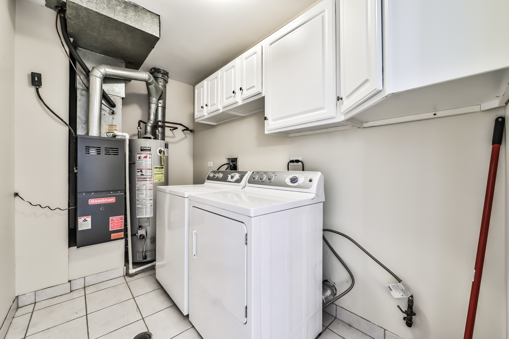 1502 7 Pines Road, Unit D2 Schaumburg, IL 60193 - Photo 32 of 34 a utility room with cabinets washer and dryer