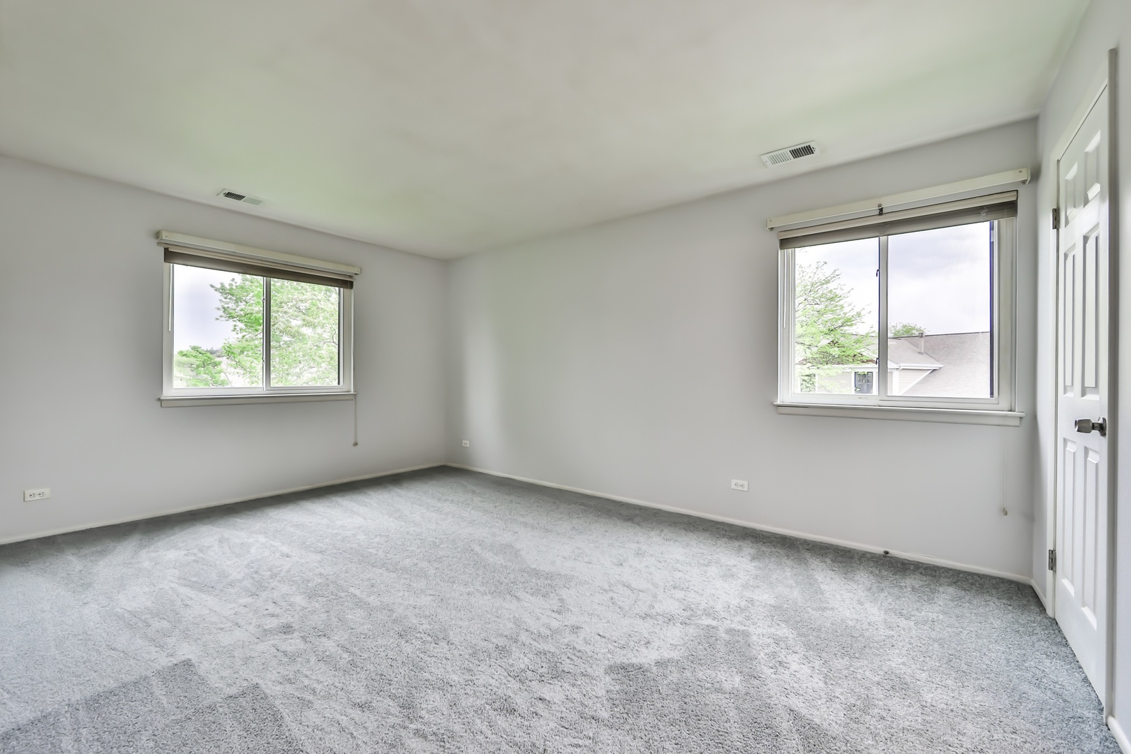 1502 7 Pines Road, Unit D2 Schaumburg, IL 60193 - Photo 6 of 34 an empty room with windows