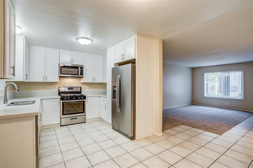 1219 Mitchell Street, Unit D Oceanside, CA 92054 - Photo 4 of 13 a kitchen with a refrigerator stove and sink