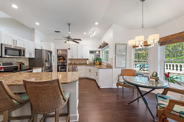a dining room with furniture a chandelier and wooden floor
