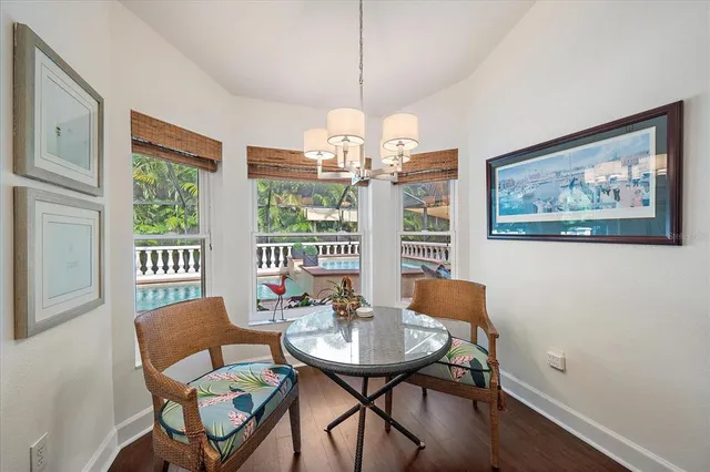 a view of a dining room with furniture wooden floor and a chandelier