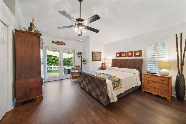 a bedroom with a large bed and a chandelier