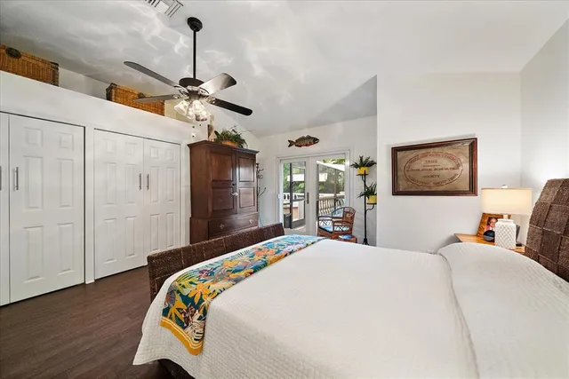 a bedroom with bed and wooden floor