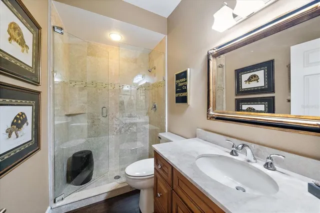 a bathroom with a sink a toilet and shower