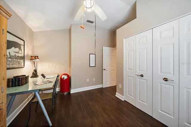 a view of a workspace with furniture and wooden floor