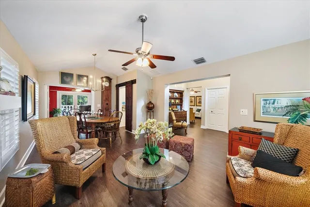 a living room with furniture a window and a chandelier