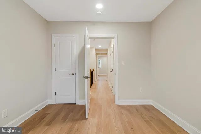 a view of a hallway with wooden floor